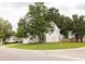 Residential street view of a two-story home with a well-kept lawn and mature trees at 407 Thomaston Ave, Summerville, SC 29485