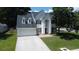 Traditional two-story home with a two-car garage, well-manicured lawn, and mature shade trees at 407 Thomaston Ave, Summerville, SC 29485