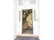Inviting foyer with wood staircase, decorative rug, and bright natural light streaming through the front door at 407 Thomaston Ave, Summerville, SC 29485