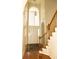 Welcoming foyer features hardwood floors, a staircase with wooden railing, and a stylish overhead light fixture at 407 Thomaston Ave, Summerville, SC 29485