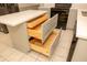A kitchen island with open wood drawers and gray cabinets with stainless steel hardware at 407 Thomaston Ave, Summerville, SC 29485