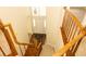 A staircase with wood railings, carpeted stairs and a view of the front door and entry way at 407 Thomaston Ave, Summerville, SC 29485