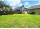 Lush green backyard with a wooden fence offering privacy and lots of space for outdoor activities at 4457 Rice Mill Dr, North Charleston, SC 29420