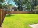 Expansive grassy backyard enclosed by a tall wooden fence, offering privacy and space at 4457 Rice Mill Dr, North Charleston, SC 29420