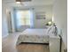 Bright bedroom with a ceiling fan, light wood floors, and nautical-themed decor at 4457 Rice Mill Dr, North Charleston, SC 29420