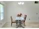 Bright dining area featuring natural light and a table setting for two, ideal for intimate meals at 4457 Rice Mill Dr, North Charleston, SC 29420