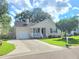 Inviting single-story home with an attached garage, spacious driveway, and a beautifully maintained lawn at 4457 Rice Mill Dr, North Charleston, SC 29420