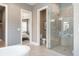 Modern bathroom featuring a glass-enclosed shower, soaking tub, and neutral color palette, creating a spa-like atmosphere at 4848 Woodville Rd, Awendaw, SC 29429