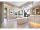 A luxurious bathroom featuring a soaking tub, dual vanities, and large windows that provide ample natural light at 4848 Woodville Rd, Awendaw, SC 29429