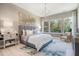 Beautiful bedroom with neutral colors, carpet, and large windows that let in plenty of natural light and an elegant chandelier at 4848 Woodville Rd, Awendaw, SC 29429