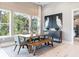 Bright dining room with large windows, modern lighting, wood floors, table with seating for six at 4848 Woodville Rd, Awendaw, SC 29429