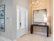 Bright entryway featuring wood accent wall, chandelier, console table with art, and an 8-lite glass door at 4848 Woodville Rd, Awendaw, SC 29429