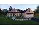 Charming two-story home with a covered porch, manicured lawn, lush landscaping, and a two car garage at 4848 Woodville Rd, Awendaw, SC 29429