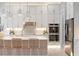 Chef's kitchen features stainless steel appliances, custom cabinets, subway tile backsplash, and breakfast bar seating at 4848 Woodville Rd, Awendaw, SC 29429