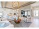 Open-concept living room flowing into the kitchen with modern decor, wood ceiling detail, and hardwood floors at 4848 Woodville Rd, Awendaw, SC 29429