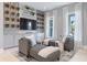 Relaxing lounge area with built-in wine storage, chaise lounges, and natural light from large windows at 4848 Woodville Rd, Awendaw, SC 29429