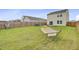 Large backyard featuring grass, a wooden privacy fence, patio seating and a hammock at 494 Pender Woods Dr, Summerville, SC 29486