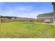 Spacious fenced backyard featuring a lush lawn, hammock, swing set, and patio, perfect for outdoor activities at 494 Pender Woods Dr, Summerville, SC 29486