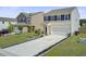 Pleasant home exterior with a lengthy driveway, green lawn, and neat landscaping enhancing curb appeal at 494 Pender Woods Dr, Summerville, SC 29486