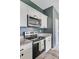 Kitchen with stainless steel microwave and range, granite countertop, and white cabinets at 494 Pender Woods Dr, Summerville, SC 29486