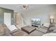 Cozy living room featuring a leather sofa, ceiling fan, and flat screen television at 494 Pender Woods Dr, Summerville, SC 29486