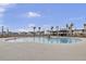 Gorgeous community pool with palm trees, a gazebo, lounge chairs, and neighborhood homes in the background at 494 Pender Woods Dr, Summerville, SC 29486
