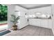 Bright kitchen featuring white cabinets, appliances, tile floors, and sliding door to the private fenced area at 507 Stinson Dr # 4G, Charleston, SC 29407