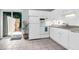 Bright kitchen featuring white cabinets, appliances, tile floors, and sliding door to the private fenced area at 507 Stinson Dr # 4G, Charleston, SC 29407