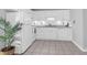 Bright kitchen featuring white cabinets, appliances, tile floors, and space for a dining area at 507 Stinson Dr # 4G, Charleston, SC 29407