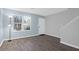 Living room featuring wood-look tile flooring, fresh paint, large window, and staircase to the second floor at 507 Stinson Dr # 4G, Charleston, SC 29407