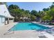 Community pool with ample seating, clear blue water, and a view of surrounding buildings at 507 Stinson Dr # 4G, Charleston, SC 29407