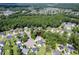 Aerial view of a home nestled in a cul-de-sac with lush trees, a pond, and nearby homes in a vibrant neighborhood at 5105 Parrum Ct, Summerville, SC 29485