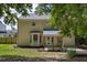 Back of home reveals a spacious yard and covered patio, perfect for outdoor relaxation and gatherings at 5105 Parrum Ct, Summerville, SC 29485