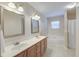 Bright bathroom featuring double sinks, vanities, tile flooring, and a separate soaking tub at 5105 Parrum Ct, Summerville, SC 29485