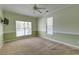 Neutral bedroom with carpet, large windows, ceiling fan, and a blank canvas for personalization at 5105 Parrum Ct, Summerville, SC 29485