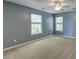 Bedroom showcasing carpet, neutral walls, two windows, and a ceiling fan at 5105 Parrum Ct, Summerville, SC 29485