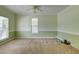Light-filled bedroom featuring carpet, two-toned green walls, and ample natural light from multiple windows at 5105 Parrum Ct, Summerville, SC 29485