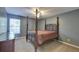 Bedroom featuring a dark-stained four-poster bed, ceiling fan, and dresser at 5105 Parrum Ct, Summerville, SC 29485