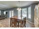 Bright dining area with a wooden table set, chandelier, and large windows providing plenty of natural light at 5105 Parrum Ct, Summerville, SC 29485