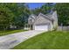Charming two-story home featuring a brick facade, a white garage door, a spacious driveway, and a well-manicured front yard at 5105 Parrum Ct, Summerville, SC 29485