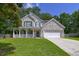 Charming two-story home with a brick facade, covered porch, and well-manicured lawn, offering curb appeal at 5105 Parrum Ct, Summerville, SC 29485