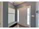Bright foyer with wood floors, a stylish entryway bench with hooks, and a white front door with sidelights at 5105 Parrum Ct, Summerville, SC 29485