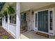 Inviting front porch with rocking chairs, hanging ferns, and a 'Welcome' mat for a warm, friendly entry at 5105 Parrum Ct, Summerville, SC 29485