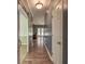 Inviting hallway features wood floors, gray walls, and an open view to a living space with natural light at 5105 Parrum Ct, Summerville, SC 29485
