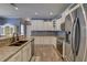 Updated kitchen with granite countertops, stainless steel appliances, white cabinets, and modern faucet at 5105 Parrum Ct, Summerville, SC 29485