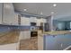 Well-lit kitchen features granite counters, stainless steel appliances, and wood-look vinyl floors at 5105 Parrum Ct, Summerville, SC 29485
