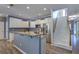 Modern kitchen with stainless steel appliances, granite countertops, white cabinets, and an adjacent staircase at 5105 Parrum Ct, Summerville, SC 29485