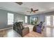 Spacious living room with fireplace, ceiling fan, and a view of the outdoor landscape from French doors at 5105 Parrum Ct, Summerville, SC 29485