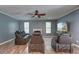 Cozy living room features hardwood floors, comfortable leather seating, a fireplace, and a large screen TV at 5105 Parrum Ct, Summerville, SC 29485