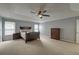 Spacious main bedroom featuring a tray ceiling, neutral walls, carpet, and large windows at 5105 Parrum Ct, Summerville, SC 29485